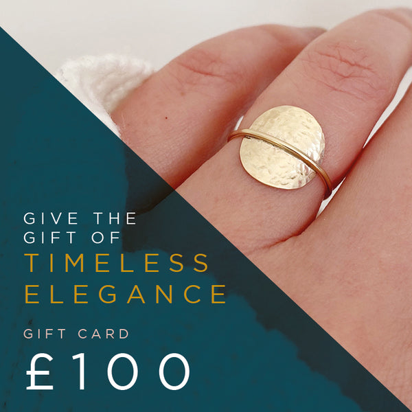 Gold ring on a finger Cicee handmade jewellery and a £100 gift card value.