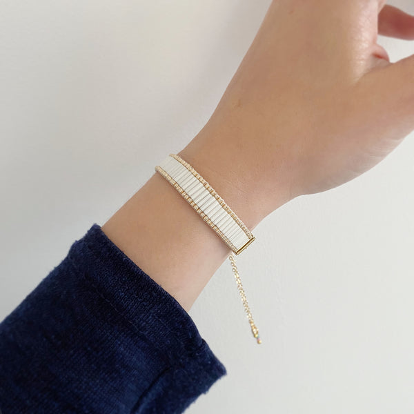 Cicee cream beaded bracelet with gold finishings on model